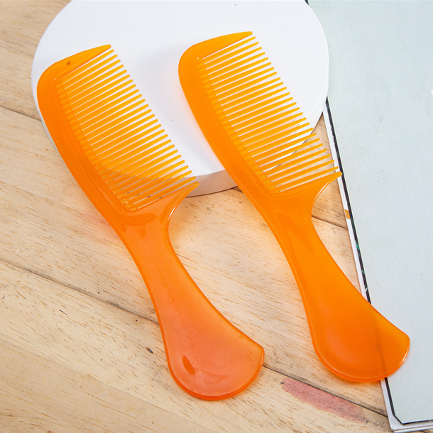 Orange anti-static plastic hair comb for detangling